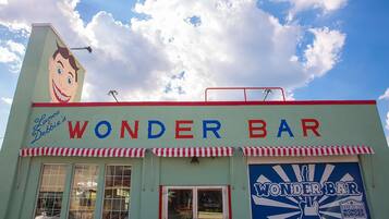 A building with a sign reading "Wonder Bar" and a large cartoon character on the side.