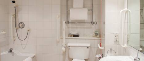 A bathroom with a bathtub, toilet, and sink.