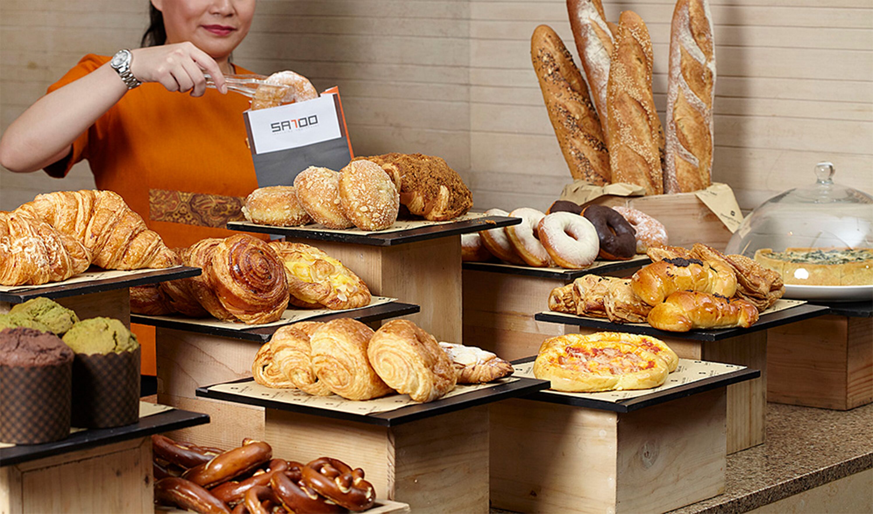 A bakery display with various pastries and bread.