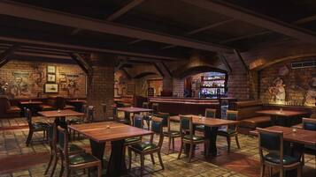 A restaurant with brick walls, wooden tables, and green cushioned chairs.
