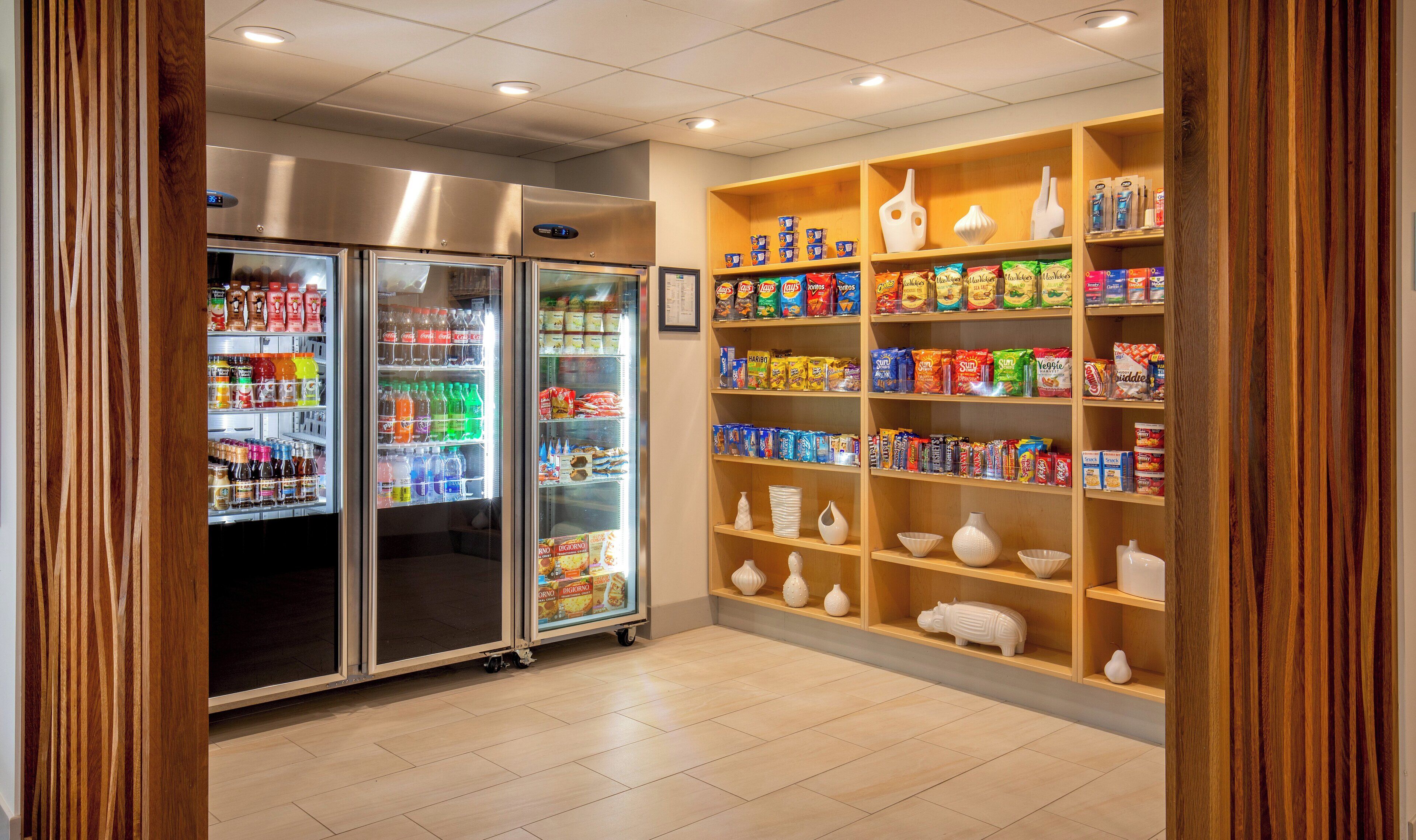 A snack and beverage vending area with multiple shelves stocked with various products.