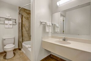 A bathroom with a toilet, bathtub, and sink. - Motel 6 Clovis, NM (Clovis)