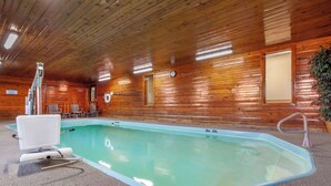 A swimming pool with a wooden interior, a lifeguard chair, and a clock on the wall. - Quality Inn Hays I-70 (Hays)