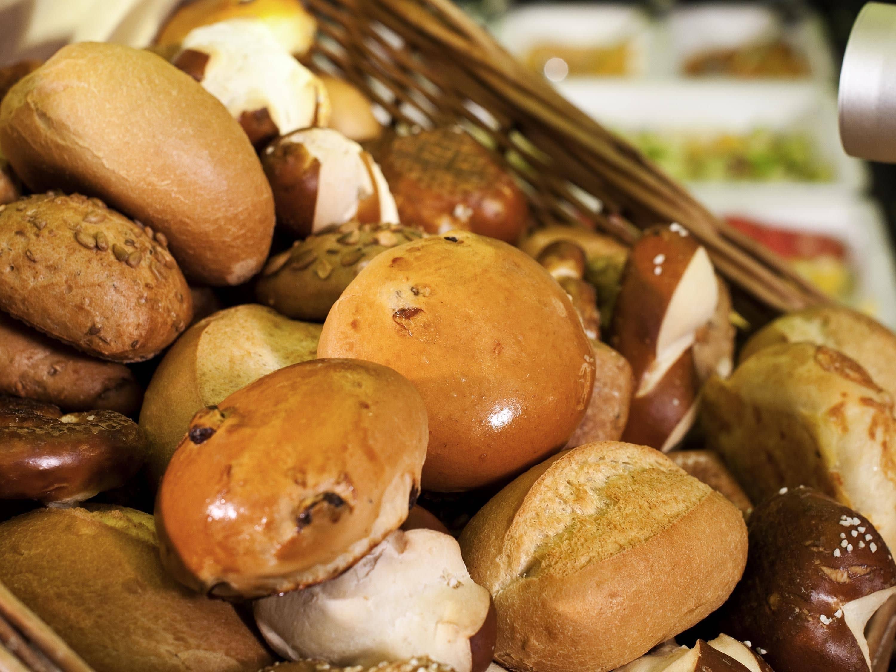 A basket filled with various types of bread and pastries.