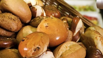 A basket filled with various types of bread and pastries.