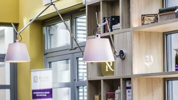 A room with wooden shelves, a window, and a lamp.