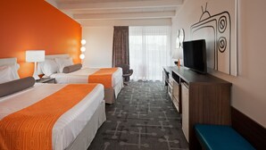 A hotel room with two beds, a television, a desk, and a bench.