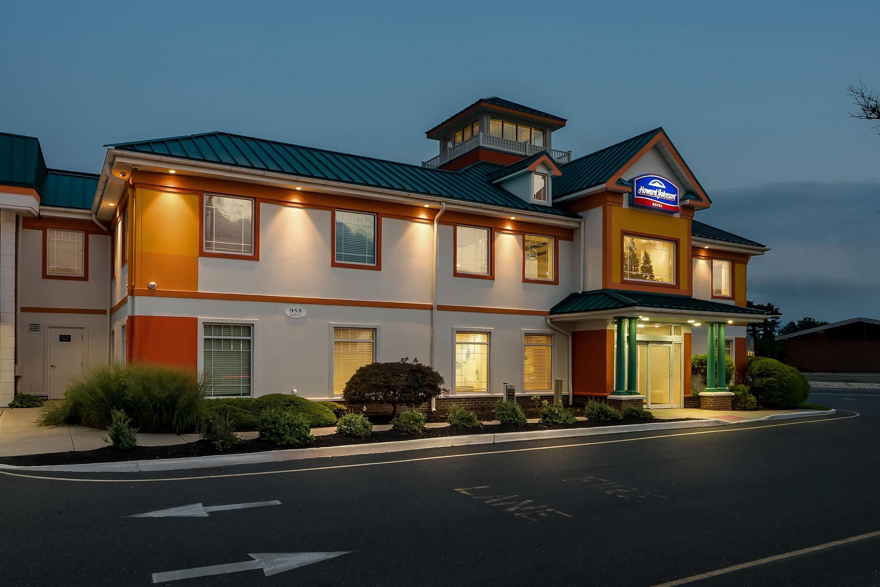 A hotel with a flat roof, multiple windows, and a sign for Howard Johnson.