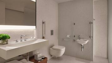 Un baño moderno con un lavamanos grande, inodoro, zona de ducha y espejo.