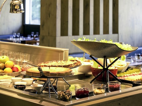 A buffet with various food items and a salad bar.. ibis Paris Porte d'Italie