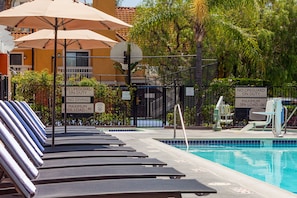 Outdoor pool, a heated pool, open 9:00 AM to 8:00 PM, pool umbrellas