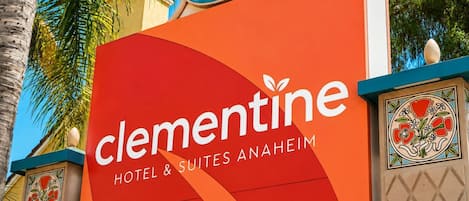 Un letrero de hotel con el nombre 'Clementine Hotel & Suites Anaheim' y la dirección '1700'.