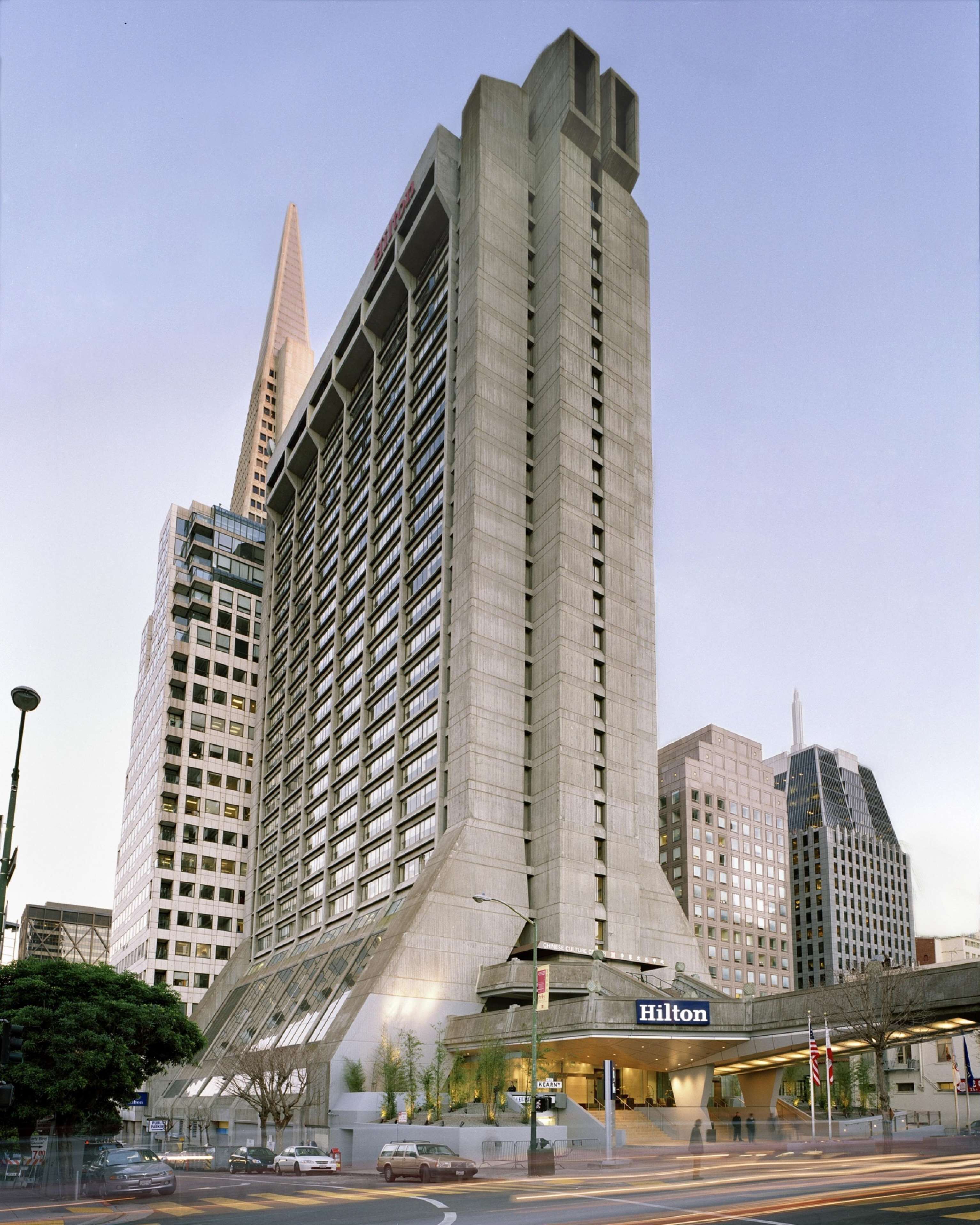 A modern hotel with a distinctive angular design, multiple floors, and a prominent entrance.