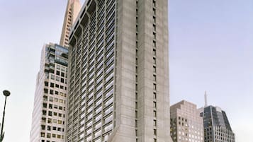 A modern hotel with a distinctive angular design, multiple floors, and a prominent entrance.