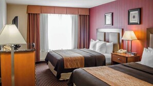 A hotel room with two beds, a desk with a lamp, a telephone, and a window with curtains. - Hotel Hanna (Harrisburg)