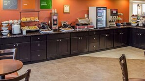 A breakfast bar with various food items and a coffee machine. - Hotel Hanna (Harrisburg)