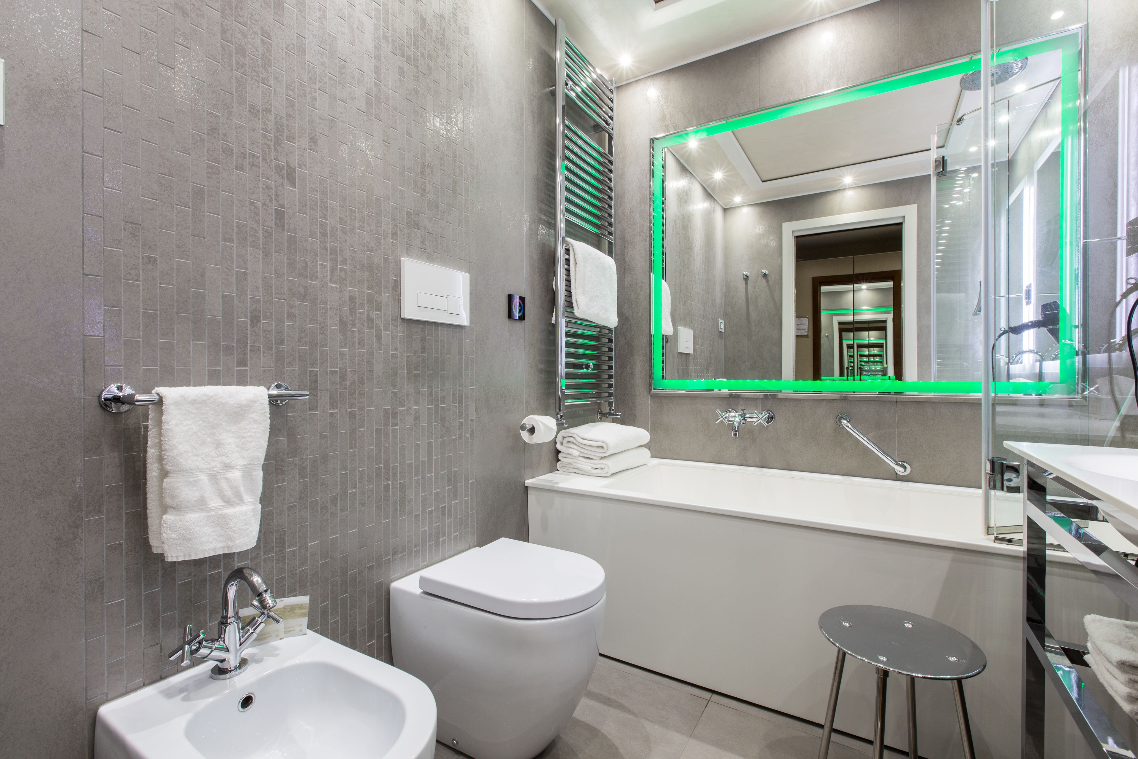 A modern bathroom with a white sink, toilet, and bathtub.