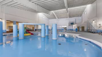 Swimmers can enjoy the pool surrounded by pillars and a slide.