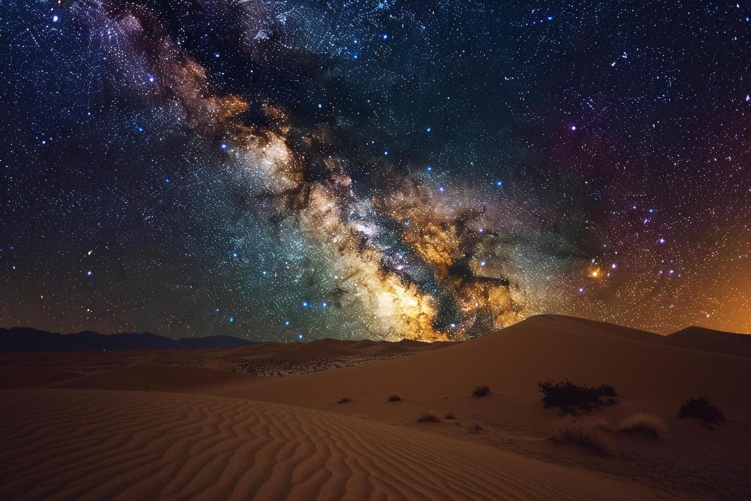 A night sky over a desert landscape with sand dunes.