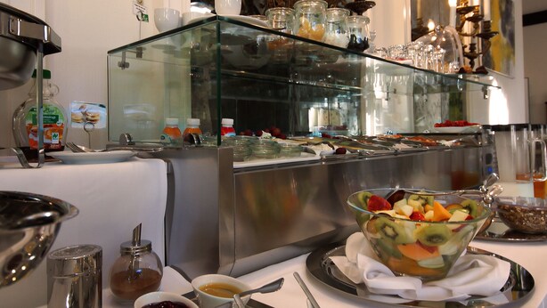 A buffet setup with various food items and condiments. - Apartmenthotel Kaiser Karl (  Self-check-in )  (Bonn)