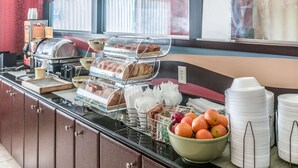 A breakfast buffet with various food items, including pastries and fruits, and a coffee station. - Quality Inn & Suites Mankato East (Mankato)