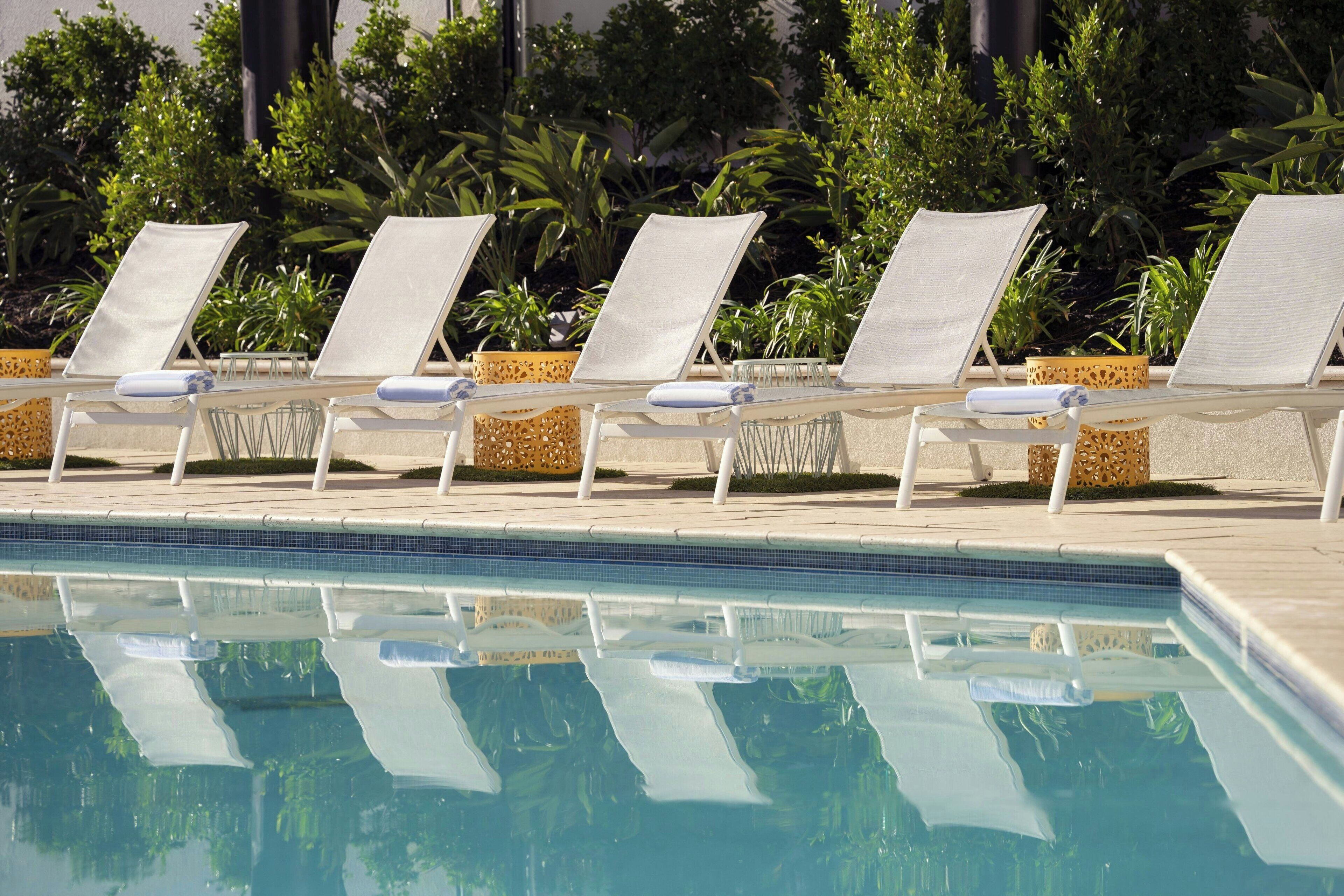 outdoor pool, open 6:00 am to 11:00 pm, pool umbrellas, pool loungers