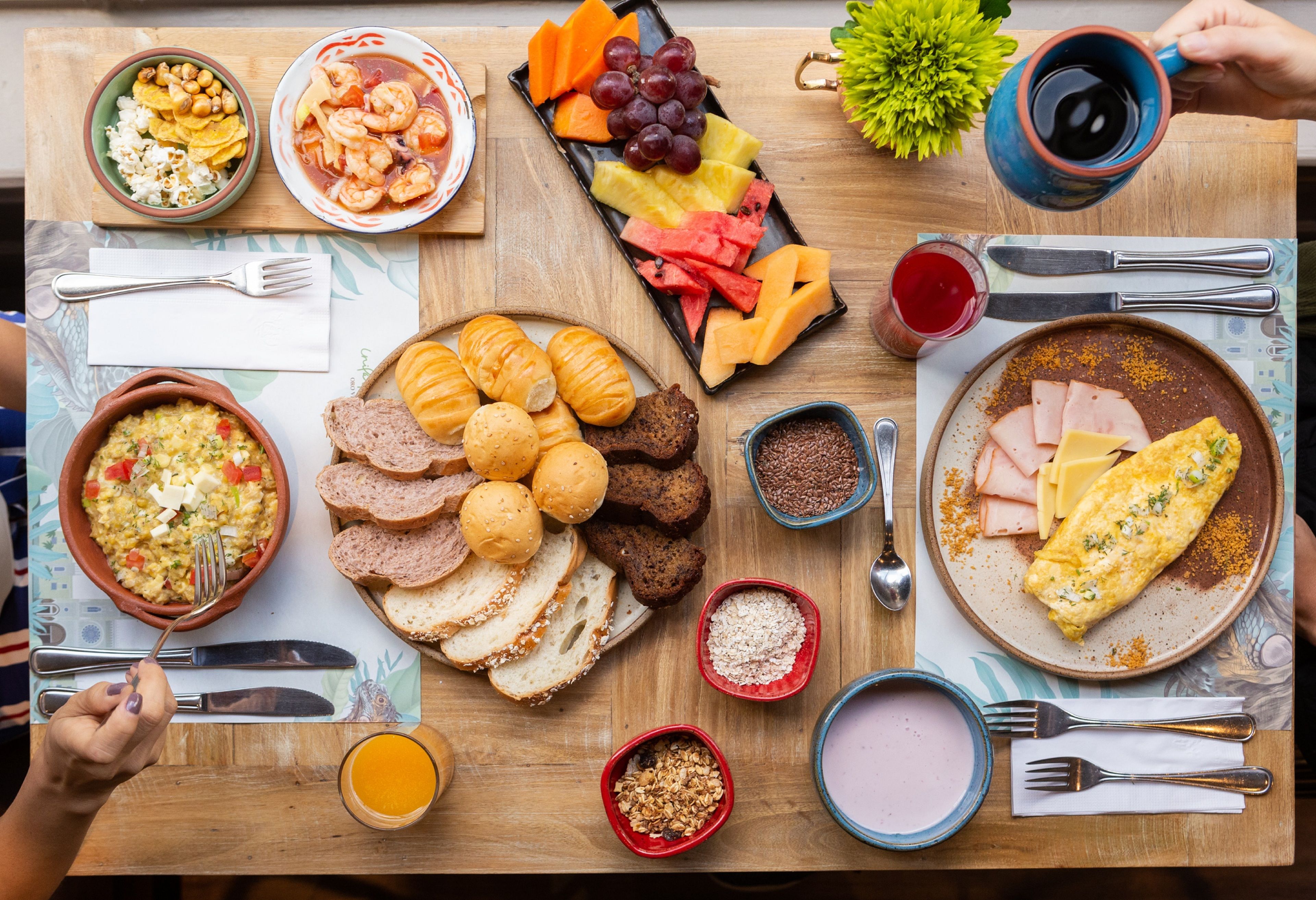 A breakfast buffet with various food items and utensils.