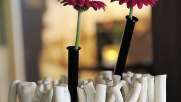 A unique vase with a modern design, featuring two flowers.