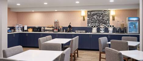 A modern breakfast area with a counter, seating, and a wall with breakfast-related graphics.