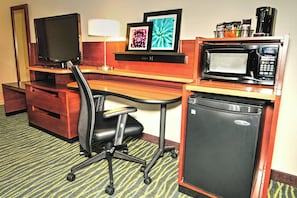 Relax in this cozy space with a desk, flat-screen TV, and kitchenette featuring a refrigerator, microwave, and coffee maker.
