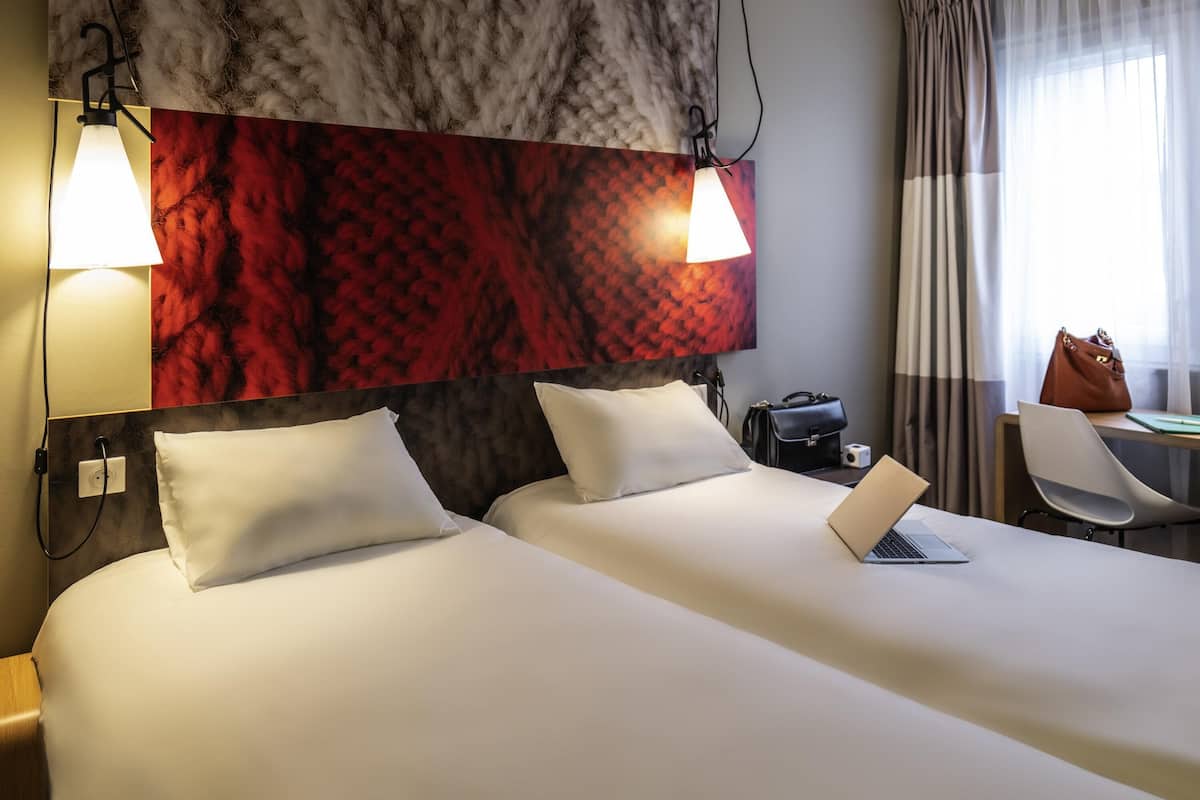 Premium bedding, desk, laptop workspace, blackout drapes