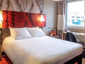 Premium bedding, desk, laptop workspace, blackout drapes