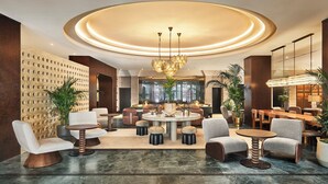A modern lobby with a central round table, seating arrangements, and a decorative ceiling. - Bristol Berlin Vignette Collection by IHG (Berlin)