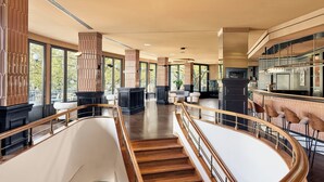 A modern interior with a staircase, seating area, and a bar. - Bristol Berlin Vignette Collection by IHG (Berlin)