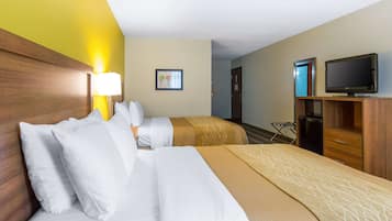 A hotel room with two beds, a TV, a desk, and a chair.