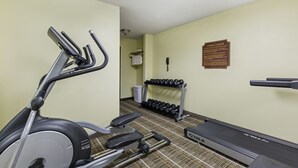 A gym with an elliptical, dumbbells, a treadmill, and a wall-mounted phone. - Quality Inn Stephens City - Winchester South (Stephens City)