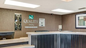 A reception area with a reception desk, a framed award, and a sign for 'Quality Inn by Choice Hotels.' - Quality Inn Mt. Pleasant (Mount Pleasant)