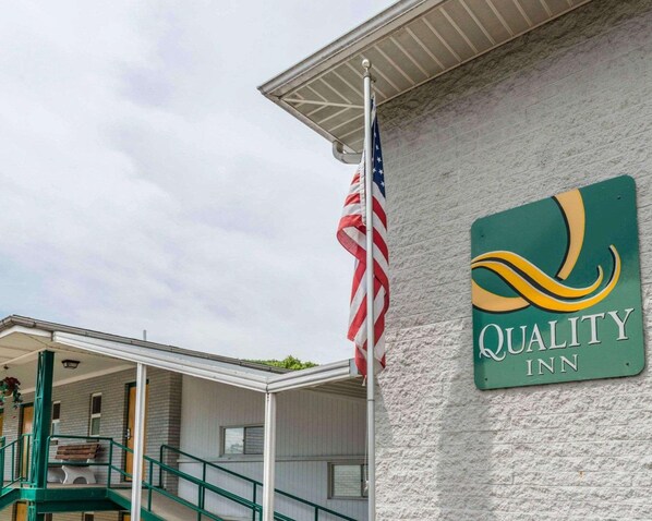 Quality Inn features a classic brick exterior and a welcoming awning over the entrance.