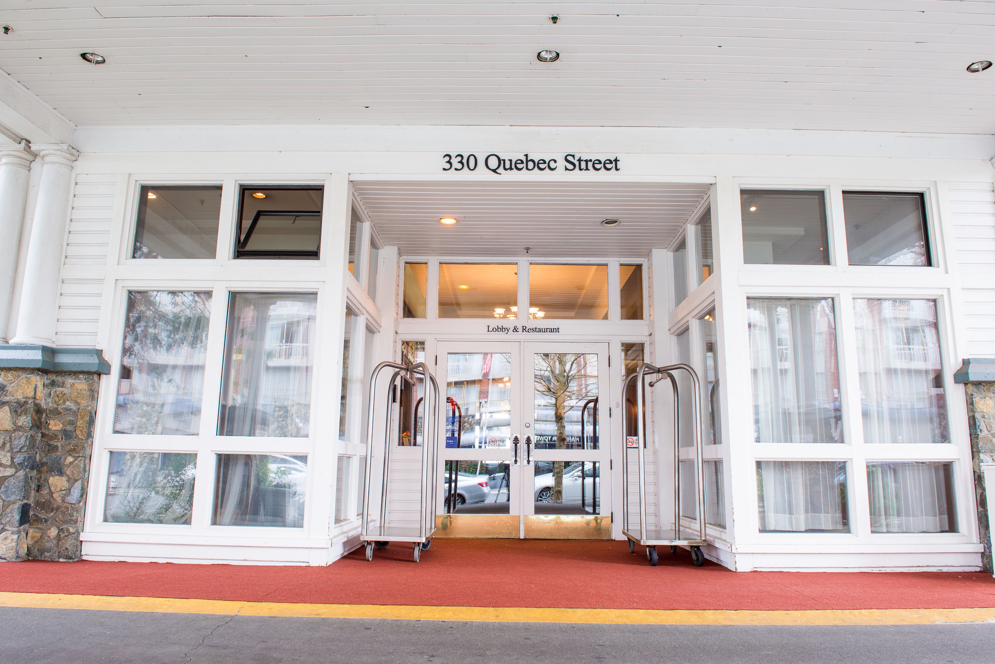 The entrance to a building with a sign reading "330 Quebec Street" and a "Lobby & Restaurant" label above the doors.