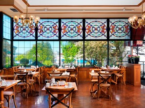 Enjoy meals in this elegant dining area with high ceilings and large windows.