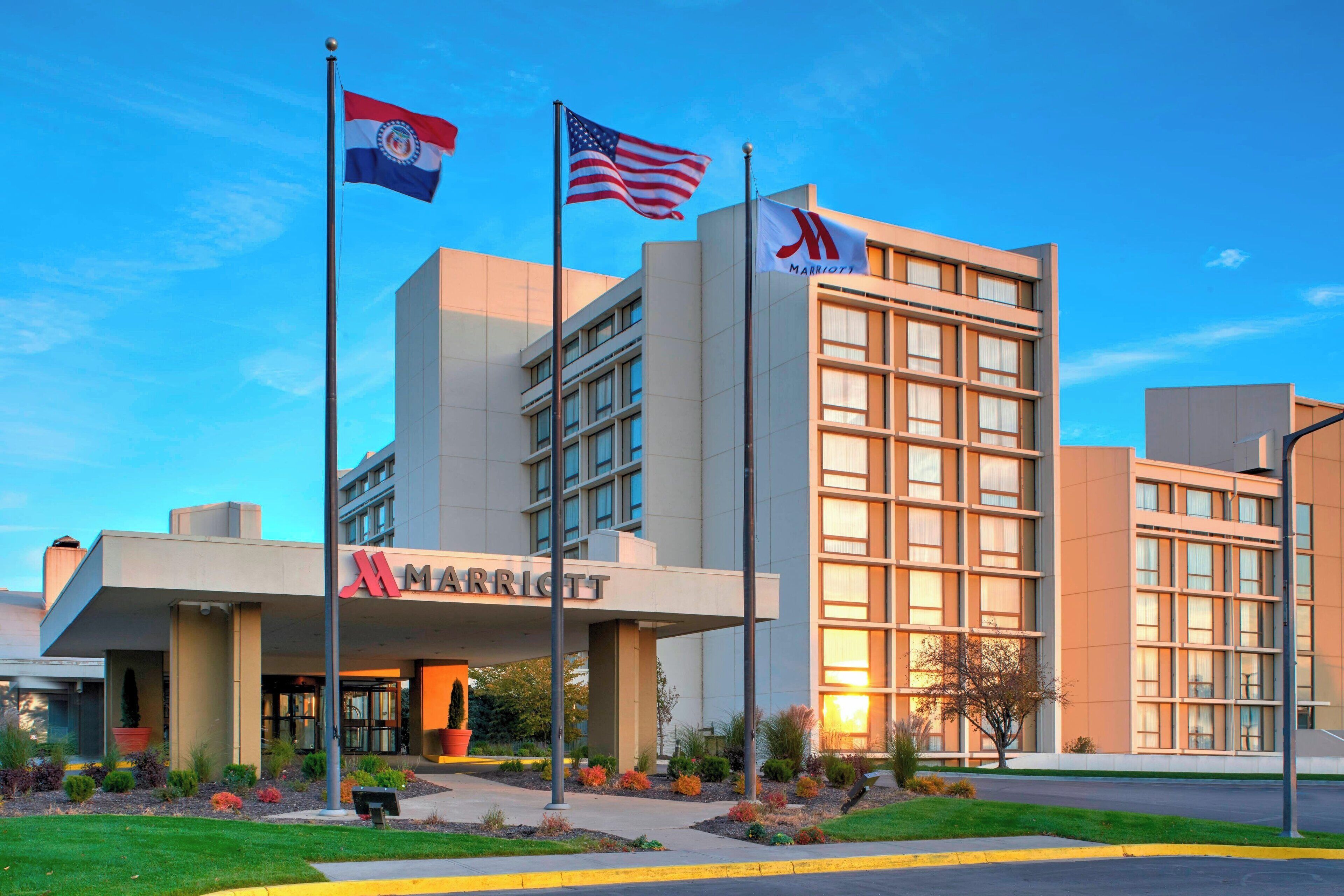 A Marriott hotel with a modern design, featuring a prominent entrance and flags.