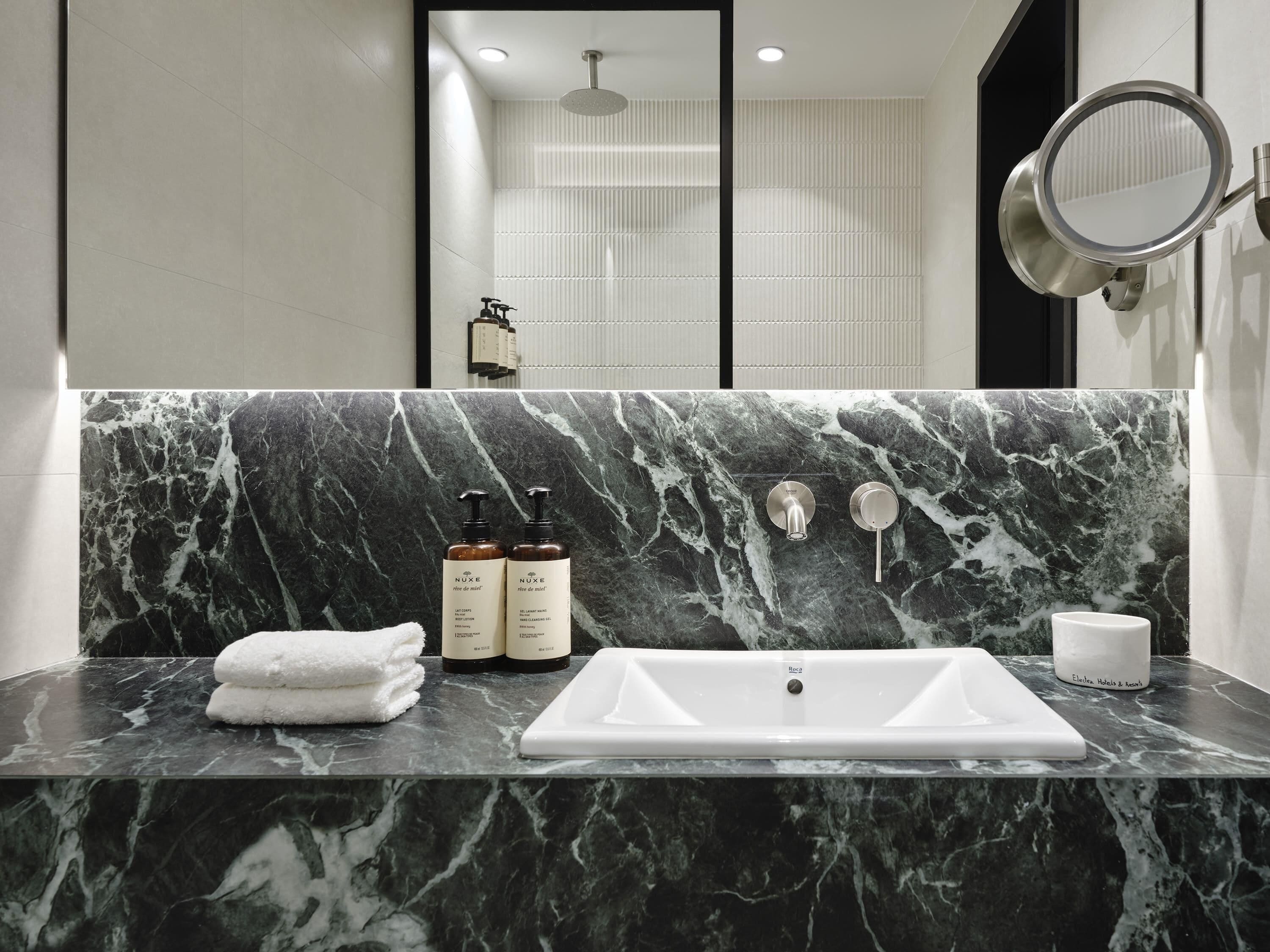 designer toiletries, hair dryer, bathrobes, slippers