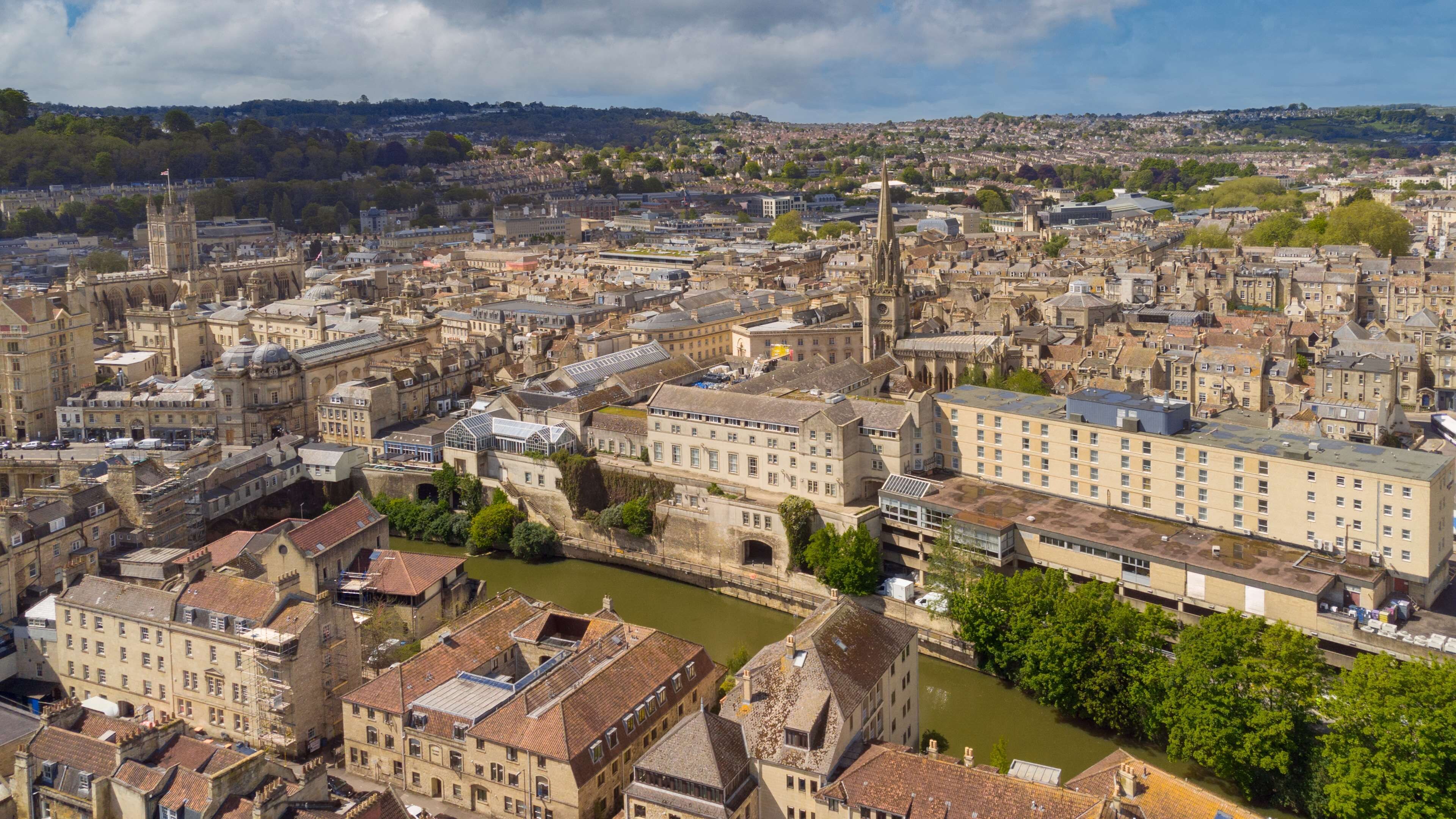 A historic cityscape with a prominent cathedral and a river running through the center.