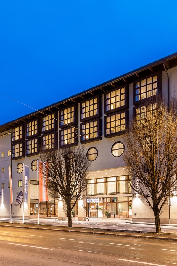 A modern building with multiple windows and a large entrance.