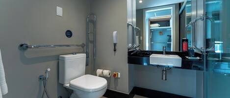A modern bathroom with a toilet, bidet, and a sink.