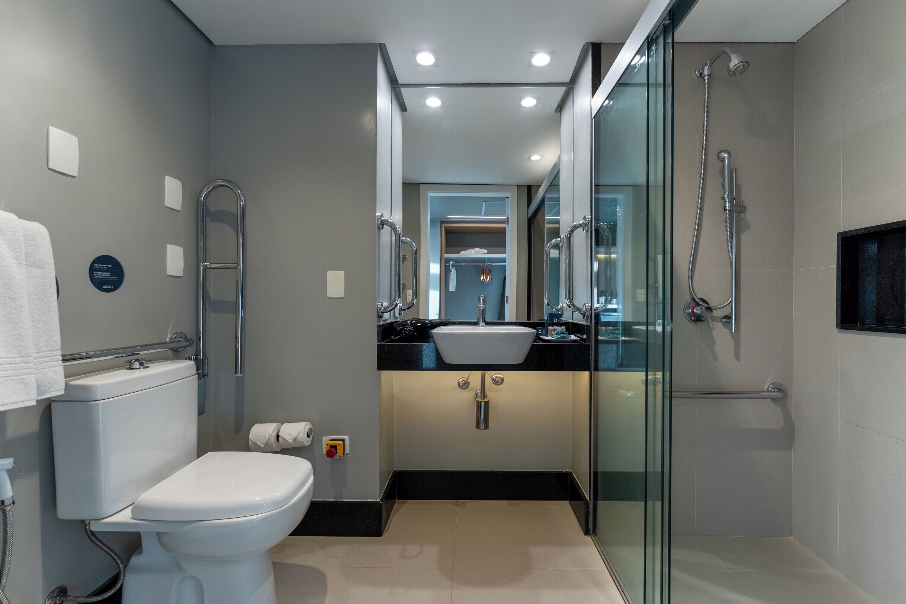 A modern bathroom with a toilet, bidet, and shower.