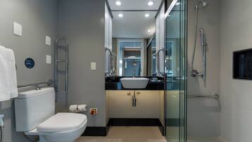 A modern bathroom with a toilet, bidet, and shower.