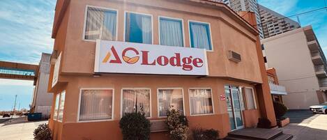 A two-story building with a sign reading 'Lodge' and a clear sky.