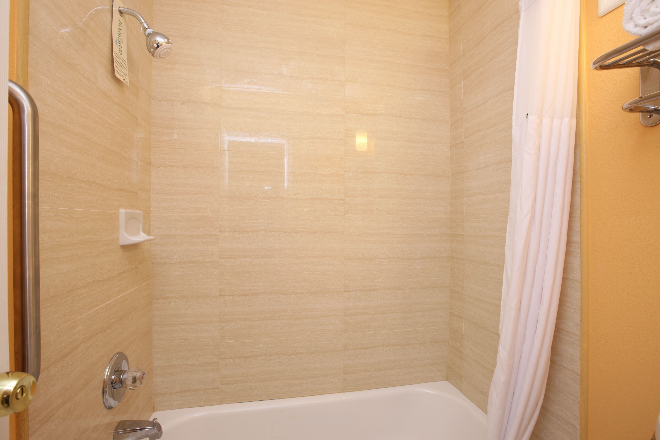 A bathroom with a shower, a bathtub, and a toilet.