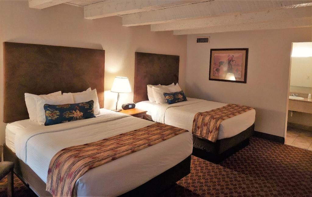 Hypo-allergenic bedding, desk, laptop workspace, blackout drapes